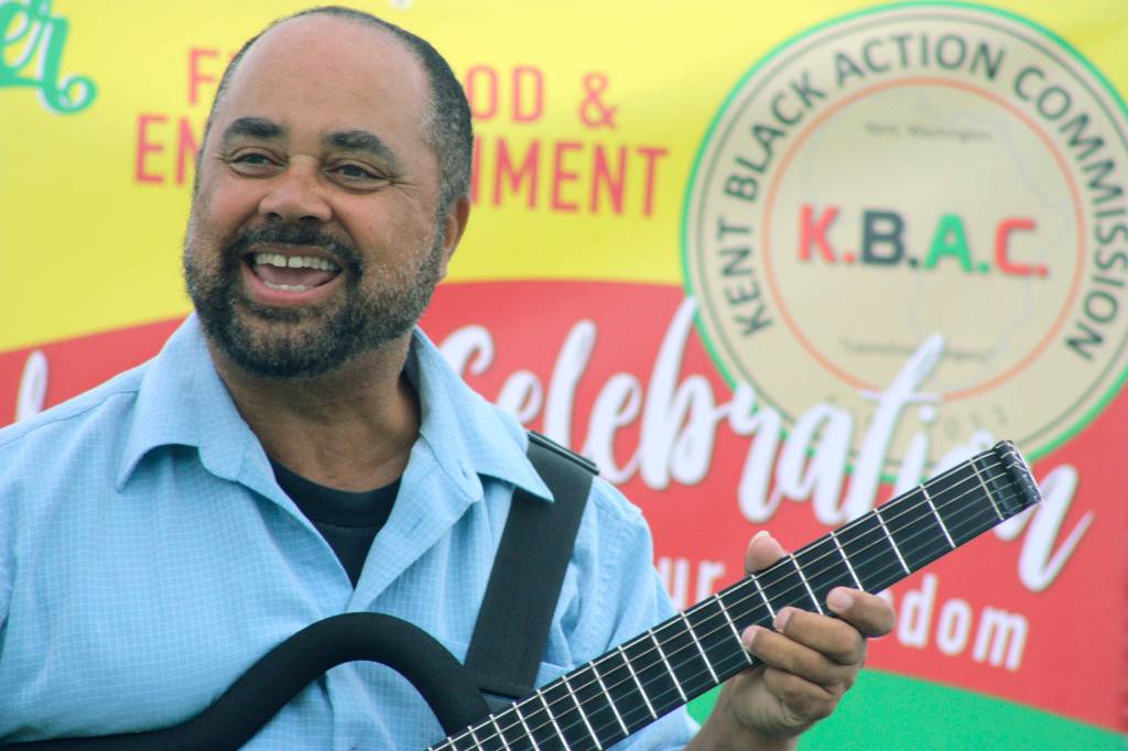 Jazz guitarist Michael Powers cranks up the music from center stage during the Juneteenth celebration at Morrill Meadows Park. MARK KLAAS, Kent Reporter