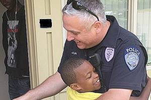 A boy, an officer and a bicycle