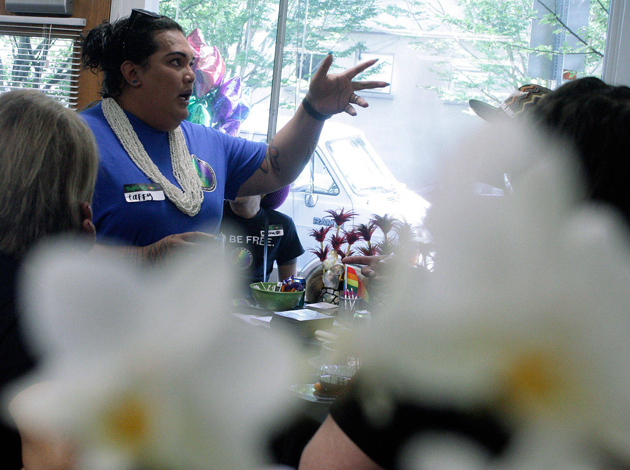 Taffy Johnson, founder and executive director of UTOPIA Seattle (United Territories of Pacific Islanders Alliance), entertains guests at the grand opening of the organizations downtown Kent center last Saturday. MARK KLAAS, Kent Reporter