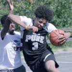 Charles Hickman, of Team Pure, powers his way to the basket against a defender from Ankle Takers BC during ninth-grade boys division play last Saturday at the Showare Shootout 3on3 basketball tournament presented by Republic Services. MARK KLAAS, Kent Reporter