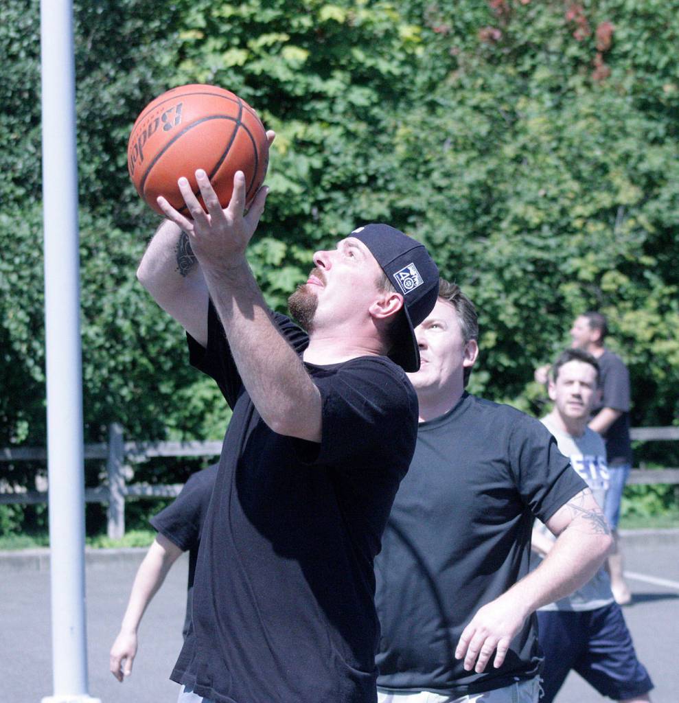 Shawn Keifer of Team TRS goes up for a shot against the Titans in adult men division 2 play. MARK KLAAS, Kent Reporter