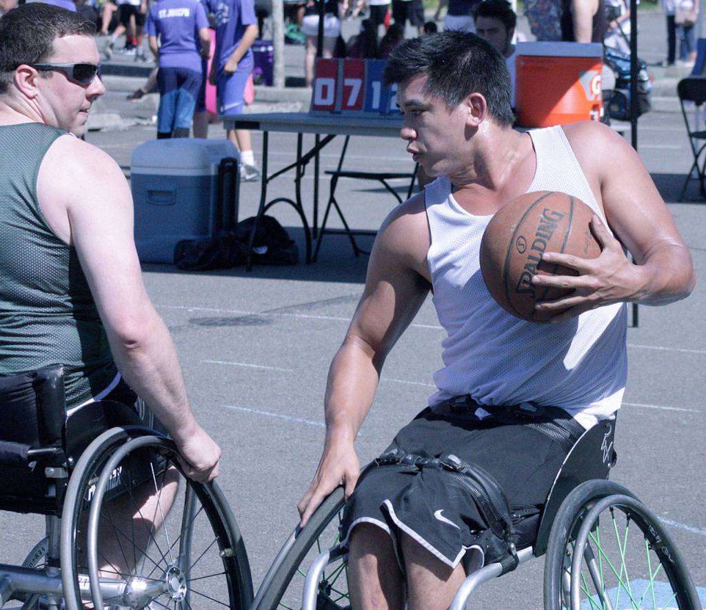 Nick Weiss of the Mystic Ballers confronts the BBB defense in wheelchair division play. MARK KLAAS, Kent Reporter