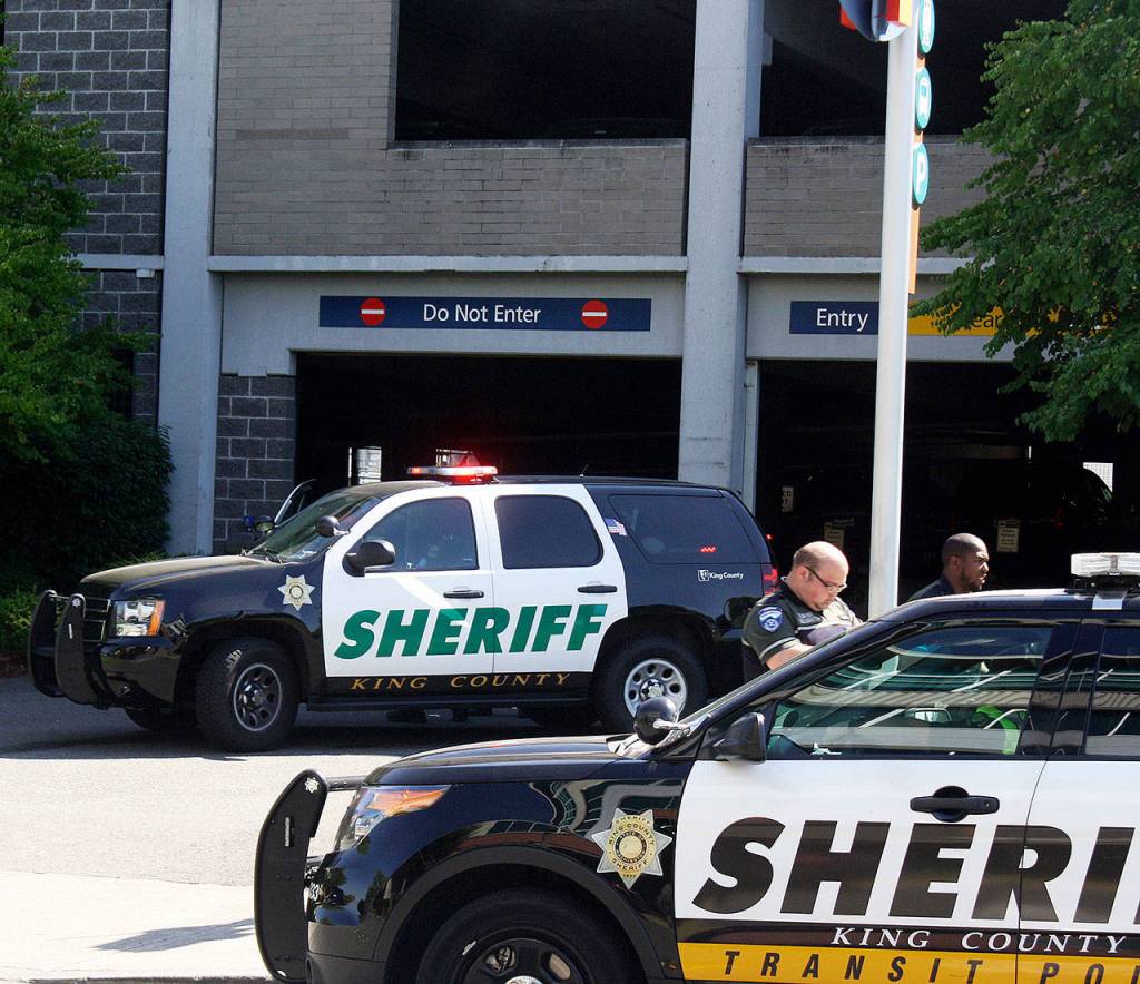 King County Sheriffs Office deputies block off access to the Kent Station parking garage Thursday morning after a deputy shot and killed a suspect in a reportedly stolen Honda Civic. STEVE HUNTER, Kent Reporter