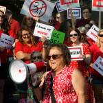 Teachers assemble in front of the Kent School District Office, listening to Lisa Brackin, an ELL teacher at Mill Creek Middle School, at the rally. MARK KLAAS, Kent Reporter