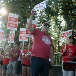Larry Delaney, a Washington Education Association board director, joins Kent teachers for a rally outside the Kent School District headquarters Thursday morning. Hundreds of teachers lined Southeast 256th Street, chanting for better pay. MARK KLAAS, Kent Reporter