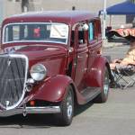 Neil Lemaster watches as his 1934 Ford Coupe, which he drove to the show from Mercer Island, glimmers in the sun last Saturday. MARK KLAAS, Kent Reporter