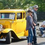 Jim Davitk, owner of a yellow 1930 Ford Model A street rod, sits quietly, as onlookers take in the classic cars. MARK KLAAS, Kent Reporter