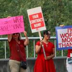 Teachers and paraeducators rally along Southeast 256th Street, outside the Kent School District Office, on Wednesday. Teachers and paraeducator unions and the school district have yet to settle the dispute over salaries. MARK KLAAS, Kent Reporter