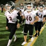 Kentlakes Hudson Potts, left, and Nathaniel Madrid walk onto the field following the Falcons 42-20 NPSL victory against the Trojans at Auburn Memorial Stadium on Thursday night. MARK KLAAS, Kent Reporter
