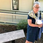 Nancy Simpson, city Landmarks Commissioner, stands by one of eight plaques that represent the historical Green River landings at a dedication ceremony for the new outdoor exhibit outside the Kent Historical Museum last week. MARK KLAAS, Kent Reporter