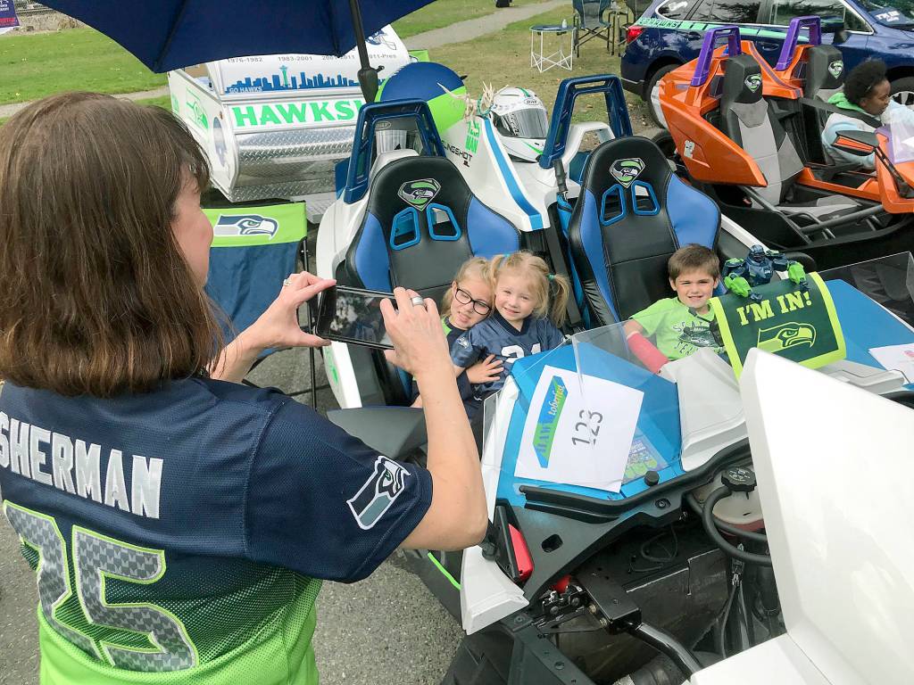 A mom captures her kids taking the wheel of a Seahawk-adorned car. MARK KLAAS, Kent Reporter