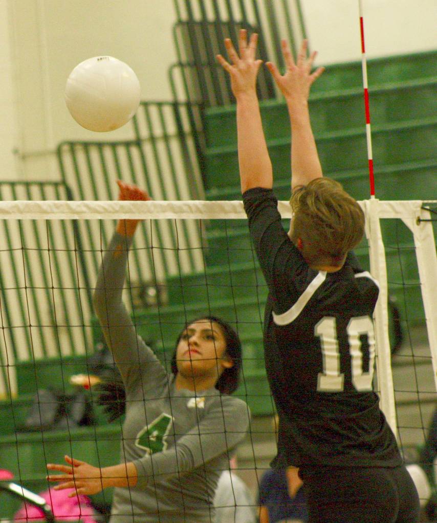 Kentridges Zaiah Calvin fires a shot past Kentlakes Chloe Hawker during Thursdays match. She had 12 kills and four digs in the three-game victory. MARK KLAAS, Kent Reporter