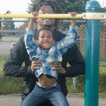 Seattle Seahawks cornerback Shaquill Griffin helps a boy do pull-ups during a playground dedication Tuesday at Park Orchard Elementary School in Kent. STEVE HUNTER, Kent Reporter