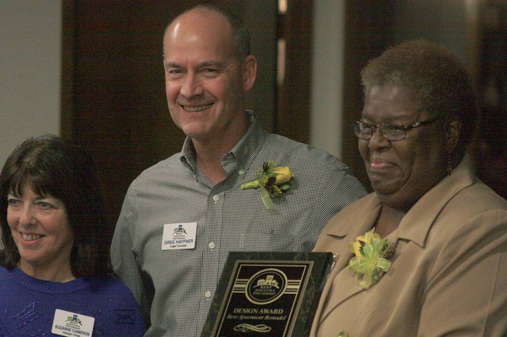 Deljuan Gibson, right, who manages Titus Apartments, receives the Best Apartment Remodel Award, with the KDPs Greg Haffner and Suzanne Cameron. MARK KLAAS, Kent Reporter