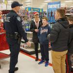 Kent Police help children shop for holiday gifts on Saturday, Dec. 8, at the Kent Target store. COURTESY PHOTO, Kent Police