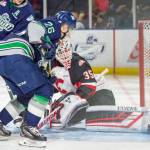 The Thunderbirds Nolan Volcan works to push the puck past Prince George goalie Taylor Gauthier during WHL play Tuesday night. COURTESY PHOTO, Brian Liesse, T-Birds