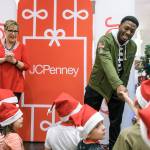 The Seahawks David Moore greets kids from the Auburn Valley YMCA after-school program as General Manager Kim Williams watches during the JCPenney Giving Spree on Tuesday, Dec. 11 in Tukwila. Stephen Brashear/AP Images for JCPenney