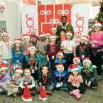 The Seahawks David Moore and SeaGals cheerleader Jessica, far left, and Shayne, far right, pose with kids from the Auburn Valley YMCA after-school program during the JCPenney Giving Spree on Tuesday, Dec. 11 in Tukwila. Stephen Brashear/AP Images for JCPenney