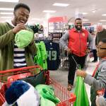 Seattle Seahawks wide receiver David Moore autographs a hat for a kid from the Auburn Valley YMCA after-school program during the JCPenney Giving Spree on Tuesday, Dec. 11 in Tukwila. In its fifth year, JCPenney is giving more than 1,200 kids a one-of-a-kind shopping experience. Stephen Brashear/AP Images for JCPenney