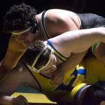 Kentwoods Victor Juarez delivers a win by fall at 285 pounds. Kayse Angel, Covington Reporter