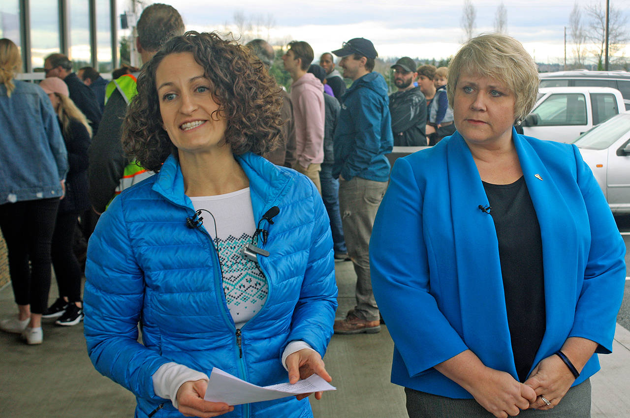 Jazmine Donovan, Dicks Drive-In executive vice president, left, and Kent Mayor Dana Ralph address the media on Thursday outside of the restaurant in an effort to remove the site from Sound Transits list of where to build a new light rail operations and maintenance yard. STEVE HUNTER, Kent Reporter