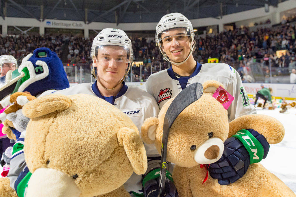Players help gather the furry donations from the Fred Meyer Teddy Bear Toss Night presented by WARM 106.9 FM. COURTESY PHOTO, Brian Liesse, T-Birds