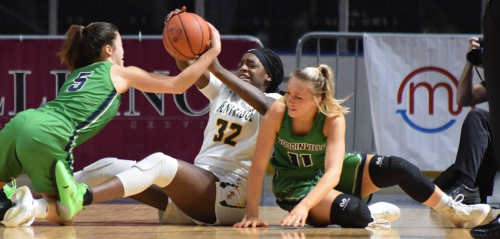 Kentridges Jordyn Jenkins scraps to get the basketball from Woodinvilles Katie Minnehan (5) and Madison DuBois (11). RACHEL CIAMPI, Kent Reporter