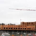 A crane looms over the Marquee on Meeker Apartments Jan. 24 under construction on the former Riverbend par 3 golf course. The first phase of the project includes a six-story building and 14 three-story buildings. MARK KLAAS, Kent Reporter