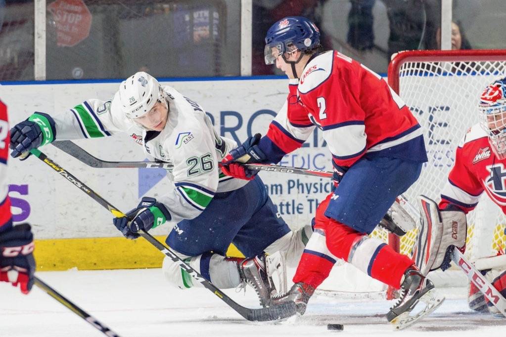 The Thunderbirds Nolan Volcan tries to move the puck in front of Hurricanes defenseman Calen Addison and Lethbridge keeper Carl Tetachuk during WHL play Friday night at the accesso ShoWare Center. COURTESY PHOTO, Brian Liesse/T-Birds