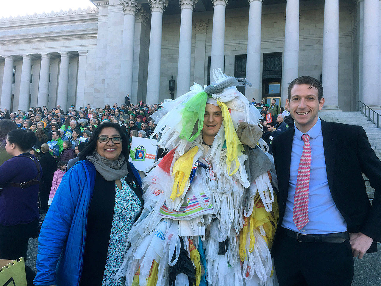 Sen. Mona Das and Rep. Joe Fitzgibbon with the Bag Monster on the steps of the Capitol Building in Olympia. COURTESY PHOTO