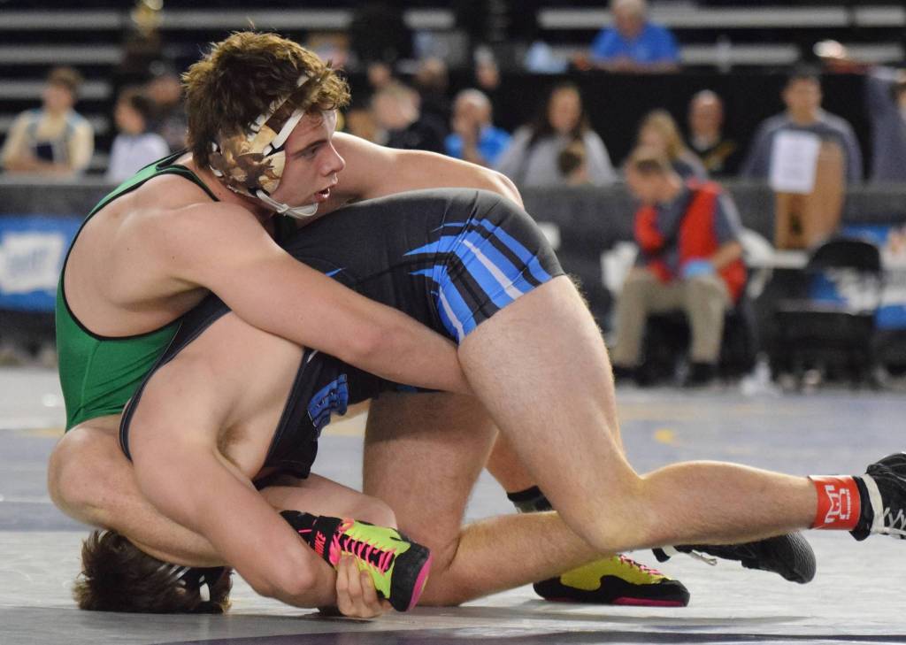 Kentwoods 195-pound sophomore Dominic Kremer, top, tangles with Central Valley of Spokanes Cade Byus during consolation round action at Mat Classic XXXI. Kremer won by a 1-0 decision to finish seventh in his weight class. RACHEL CIAMPI, Kent Reporter