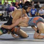 Kentwoods Alex Long, top, battles Auburn Mountainviews Brennen Hanson during their 152-pound semifinal at Mat Classic XXXI at the Tacoma Dome on Saturday. Long pulled out a 4-3 decision to reach the final. RACHEL CIAMPI, Kent Reporter