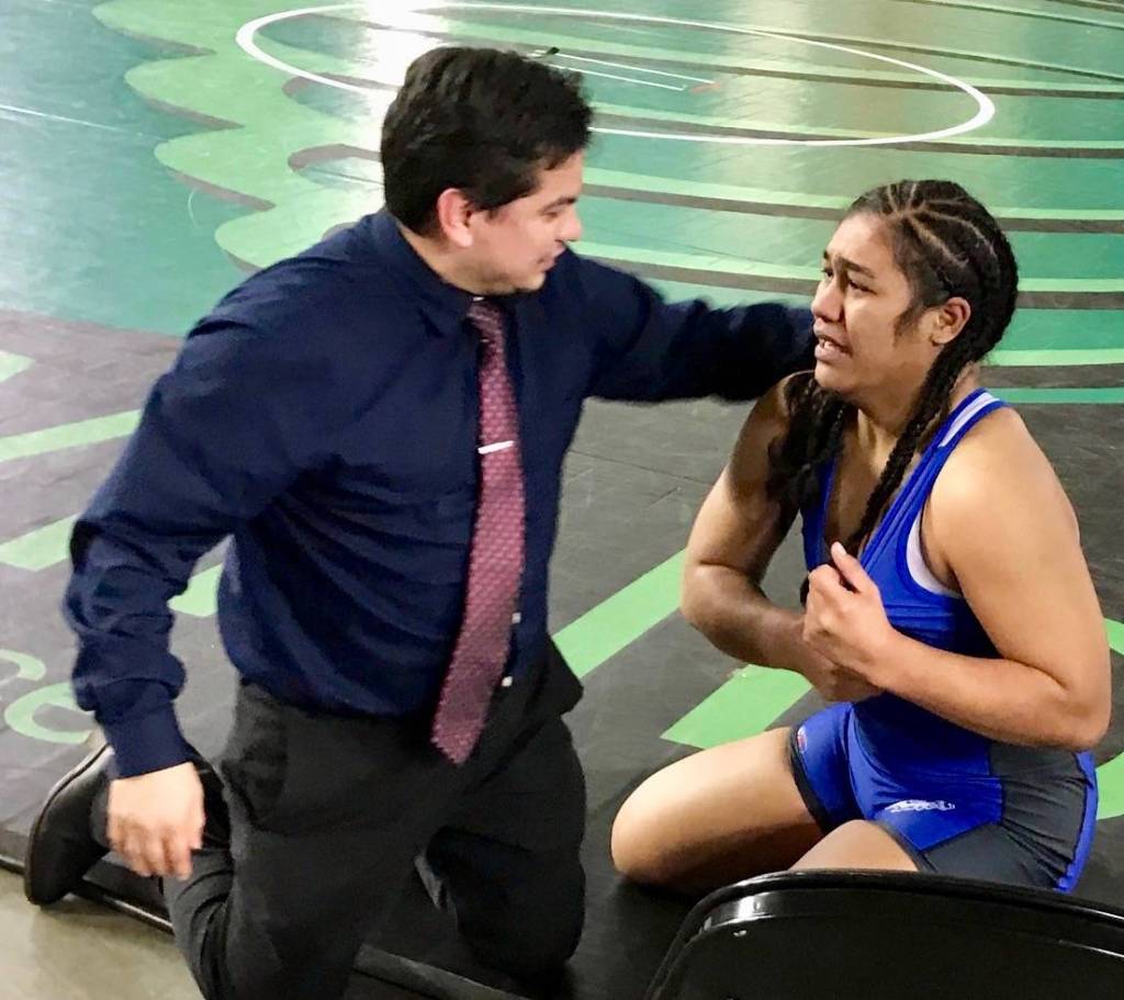 Kent-Meridian coach Jesus Valdez talks to Ofa He Lotu Tuifua after the sophomore captured the 190-pound title at Mat Classic XXXI. MARK KLAAS, Kent Reporter