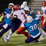 Auburn Riverside defenders bring down Kennedy Catholics Junior Alexander during North Puget Sound League Mountain Division action in Oct. 2018 at Auburn Memorial Stadium. Photo by Rachel Ciampi/Auburn Reporter