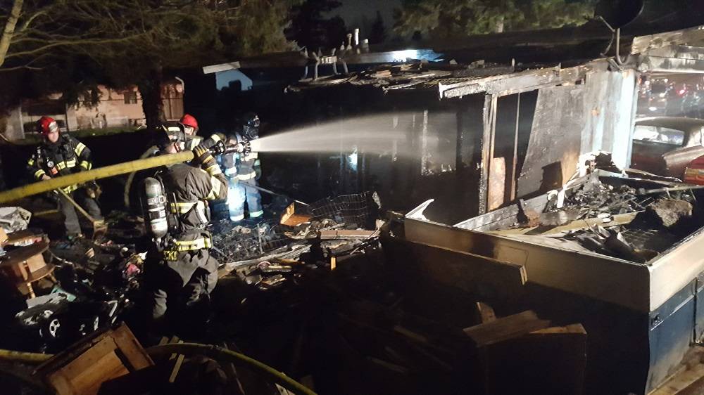 Puget Sound Regional Fire Authority crews douse a deck fire at a home on Kents East Hill early Saturday morning. COURTESY PHOTO, Puget Sound RFA