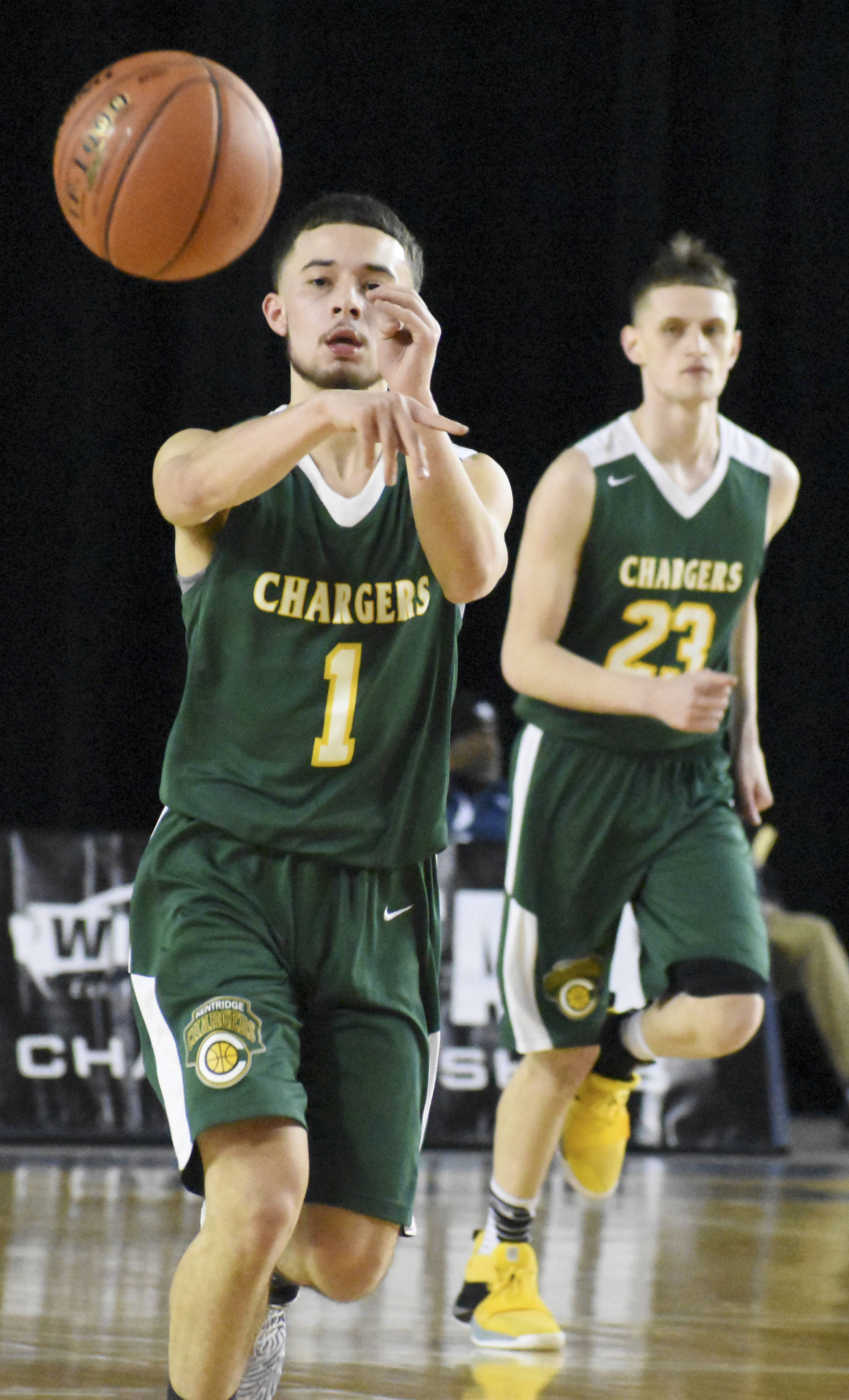 Kentridges Cruz Medina passes the ball on the break with teammate Jett Briceno running up-court during 4A Hardwood Classic play at the Tacoma Dome. The Chargers open the tournament with a win but dropped their next two games to meet elimination. KEVIN HANSON, Enumclaw Courier-Herald.