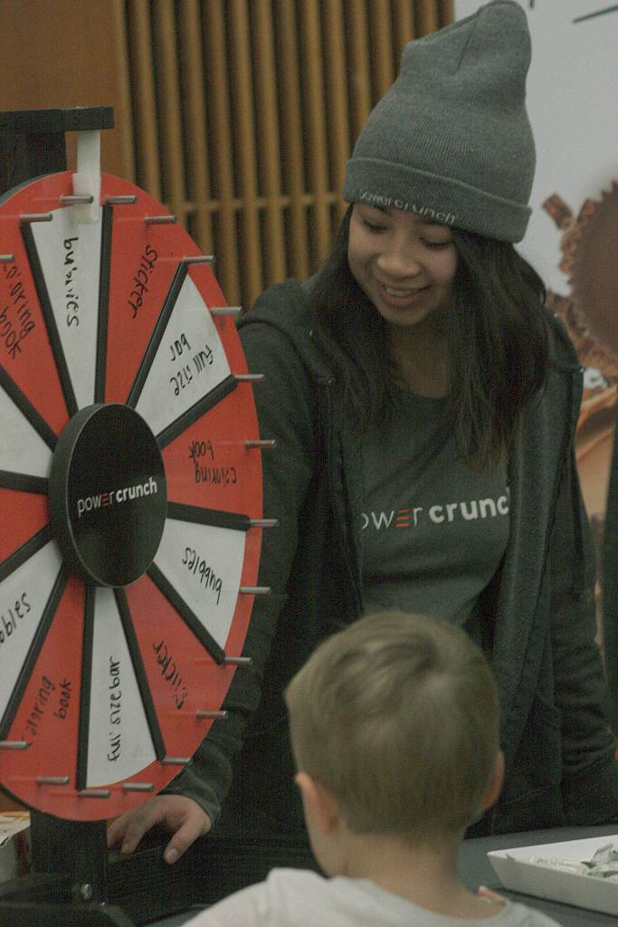 Katherine Nguyen, representing Powercrunch, has visitors spin the wheel of fortune. MARK KLAAS, Kent Reporter