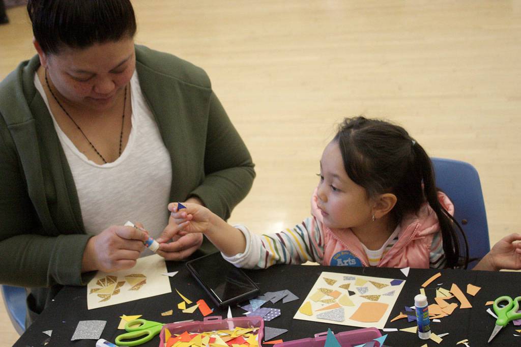 Di Cabere helps her daughter, Aci, 4, make a mosaic. MARK KLAAS, Kent Reporter