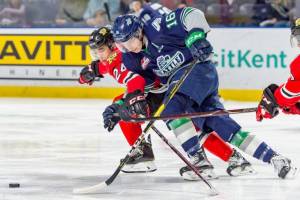 The Thunderbirds Noah Philp, right, drives the puck up the ice with the Winterhawks Seth Jarvis defending during their WHL game at the accesso ShoWare Center on Saturday night. COURTESY PHOTO, Brian Liesse, T-Birds