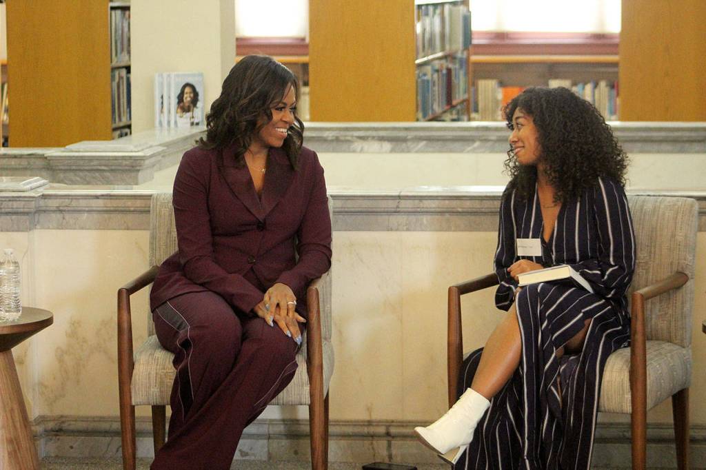 Former First Lady of the United States Michelle Obama, left, chats with Lestraundra Alfred, founder of Balanced Black Girl podcast at a private book club event at the Tacoma Public Library on Sunday, March 24. Olivia Sullivan/Federal Way Mirror