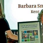 Barb Smith, executive director of the Kent Downtown Partnership, right, receives the Washington State Main Street Programs 2019 Leadership on Main Award from Breanne Durham, Washington State Main Street Program coordinator, during a ceremony Monday. COURTESY PHOTO