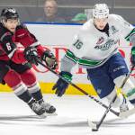 Thunderbirds center Noah Philp pushes the puck up the ice with the Giants Dylan Plouffe during Game 6 action Saturday night. COURTESY PHOTO, Brian Liesse, T-Birds