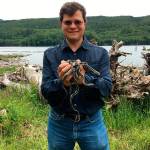 Seattle District fishery biologist Rafael Lopez-Gonzalez holds garter snakes above Howard Hanson Dam. Rafael is working with a team of herpetologist from U.S. Army Engineer Research and Development Center (ERDC) conducting field studies to survey for reptiles and amphibians at Mud Mountain Dam and Howard Hanson Dam. COURTESY PHOTO, Dallas Edwards