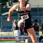 Kentwood sophomore Emma Pollak glides to victory in 300-meter hurdles at the North Puget Sound League track and field meet at Auburn Memorial Stadium on May 9. Pollak, who owns the states fastest time in the event at 44.11 seconds, won the league final in 45.39 to advance to this weeks West Central District meet at Sumner. RACHEL CIAMPI, Kent Reporter