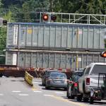 A train sweeps through downtown Kent while blaring its horn as motorists wait patiently to cross the tracks on West Gowe Street. MARK KLAAS, Kent Reporter