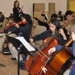 Monica Camp directs the orchestra at Excel Public Charter School. 2015 FILE PHOTO