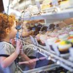 A child looks into the tasty possibilities on display at Sweet Themes Bakery in Kent. COURTESY PHOTO