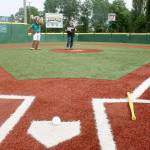 Kent Mayor Dana Ralph, accompanied by Mariner Moose, addresses the gathering for the grand opening of Wiffco Field next to Kent Memorial Park on Tuesday. Kent has the first Wiffle Ball Inc.,-sanctioned field in the state. MARK KLAAS, Kent Reporter