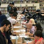 Volunteers from the business and financial organizations guided Kent-Meridian students on how manage money at the recent Financial Reality Fair. COURTESY PHOTO