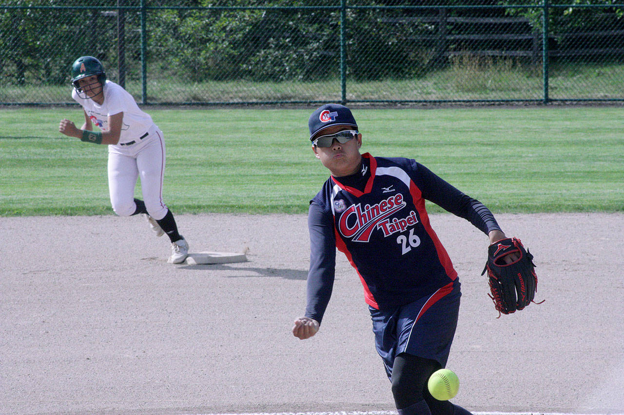 Chiu An-Ju, of the Chinese Taipei Olympic womens team, delivers a pitch as Acer alum Destiny Conerly prepares to advance from second base during their exhibition softball game at the Service Club Community Park Ballfields in Kent on Thursday. Conerly led off the first inning with a double but was left stranded. MARK KLAAS, Kent Reporter